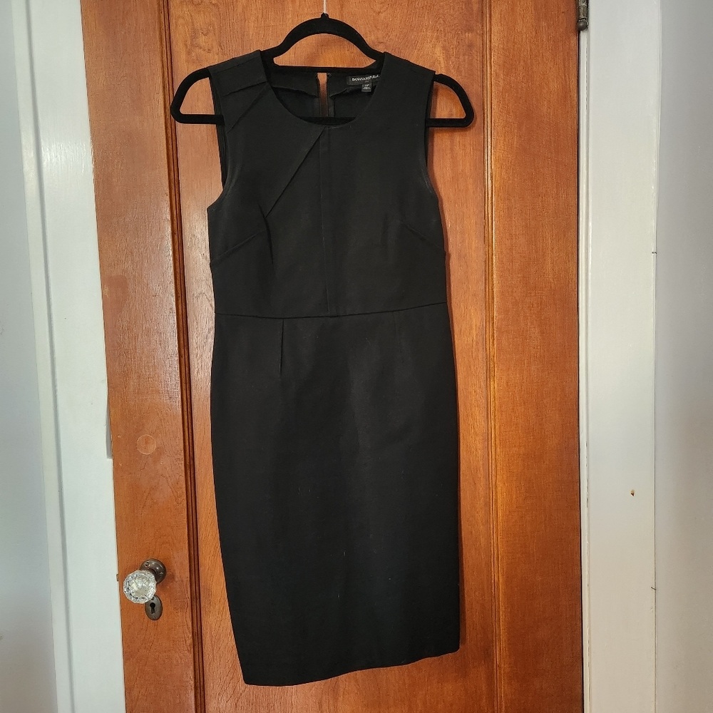 Black, fitted sheath dress w/asymmetrical design. Sz. 4P. Banana Republic.